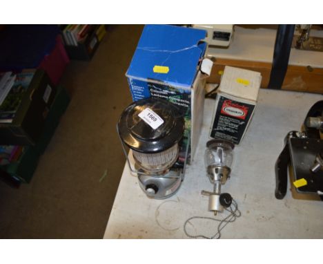 A Coleman's hurricane lamp together with a primers hurricane lamp 