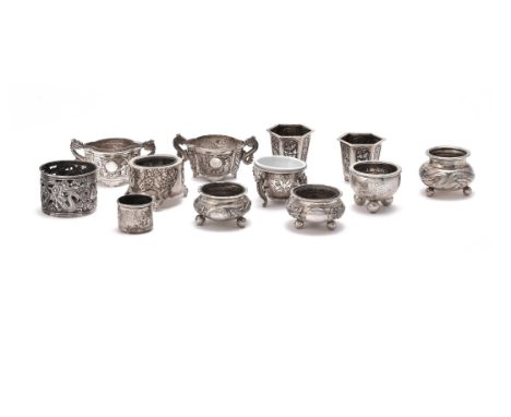 A selection of twelve Chinese export silver salts, late 19th-early 20th century, comprising: a pair of lobed 'Dragon' salts, 