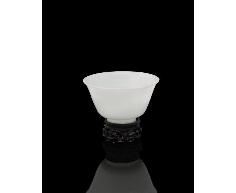 A Chinese opaque white Peking glass bowl, Qing Dynasty, late 19th century, of round form on short feet, 9.8cm diameter, with 