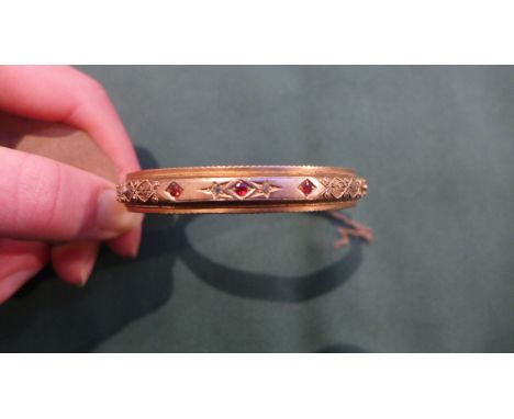 Half hoop bangle set with three ruby stones, two rose cut diamond points, hallmark 9ct (11gms)