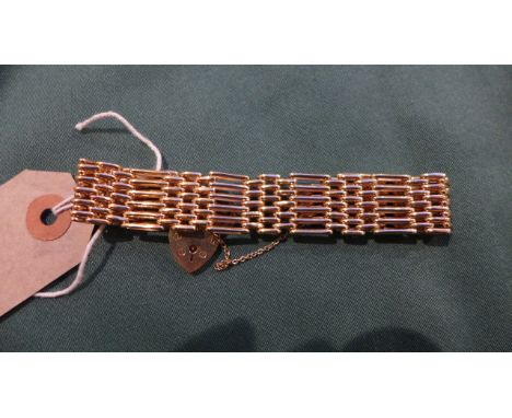 A 9ct gold six bar gate bracelet with padlock catch (Birmingham 1973) (28gms.)