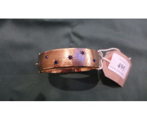 9ct gold bangle inset 7 star cut sapphires (28gms)  CONDITION REPORT (GUIDELINE): 29g9ct .375 Birmingham 19902.25" x 2.5" whe