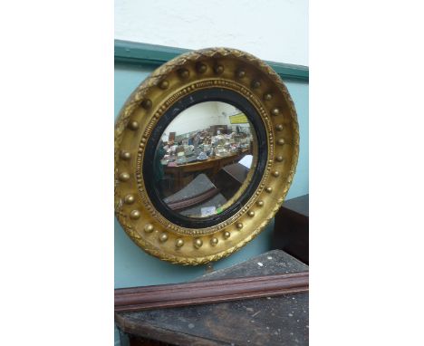 Circular convex mirror in ornate garland gilt frame
