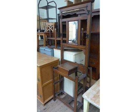 Oak hall stand, the upper portion fitted central rectangular mirror, small cupboard and storage compartments below