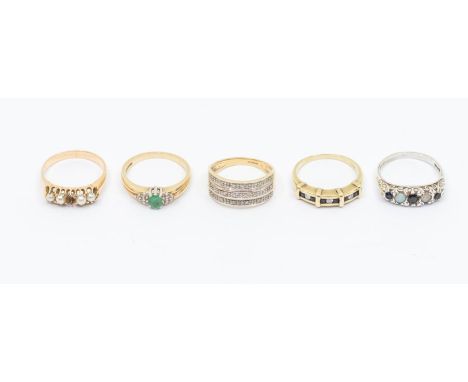 A collection of 9ct gold rings to include a diamond set multi row ring, size P, an emerald and diamond dress ring size P, a d