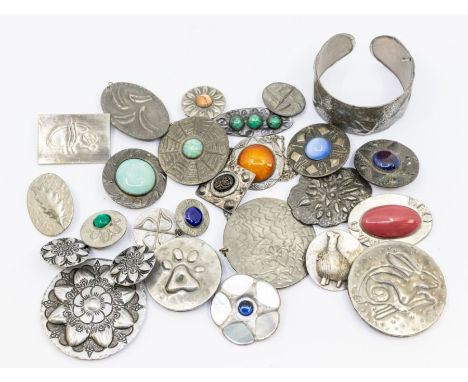 A collection of pewter coloured jewellery to include Ruskin style brooches with enamel centres, along with some paste set ver