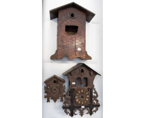 A collection of cuckoo clocks; Black Forest example, a case and modern cuckoo clock case AF
