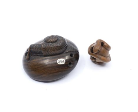 A Japanese netsuke in the form of a snail on a mushroom along with a boxwood ojime formed as a coiled snake