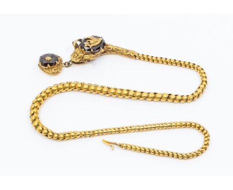 A Victorian yellow metal snake necklace, comprising a decorative textured gold head with faceted garnet overlaid with rose cu