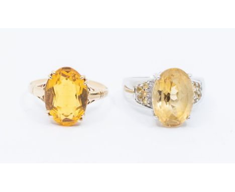 A 9ct white gold and citrine dress ring set with an oval citrine, approx 9 x 13mm, further stones set to shoulders, size N1/2