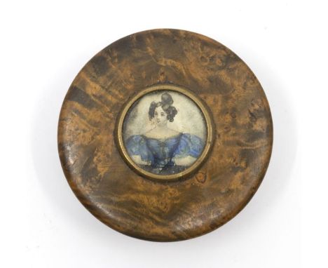 A George III circular treen snuff box, tortoiseshell lining, the cover set with a central circular watercolour portrait of a 