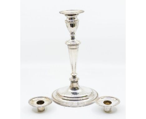 A George III Neo-Classical candlestick, urn shaped sconce above tapering stem on raised oval foot, with reeded and fluted dec