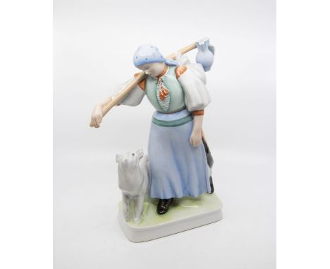 Zsolnay Pecs; a Hungarian figure of a young lady in traditional clothing with dog, factory marks and artists signature to bas