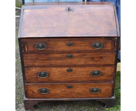A Georgian bureau in mahogany on bracket feet, with issues