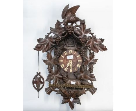 A good late Victorian cuckoo wall clock. All original Black Forest case with carved grapes, leaves and a wolf. Leaf pendulum.