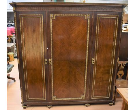 Late 19th Century mahogany empire three door wardrobe with two either side hanging space with central pull of linen drawers a