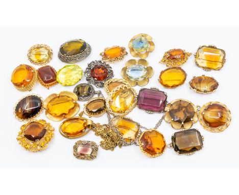 A collection of vintage metal and paste set brooches, mainly gilt metal with citrine coloured paste along with three pendants