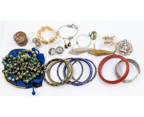 A collection of Oriental themed jewellery items to include two articulated silver/silver gilt pendants with hidden compartmen