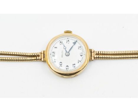 An early 20th Century ladies 9ct gold Rolex watch, round white enamel dial, Arabic numerals, approx 23mm, to a 9ct gold snake