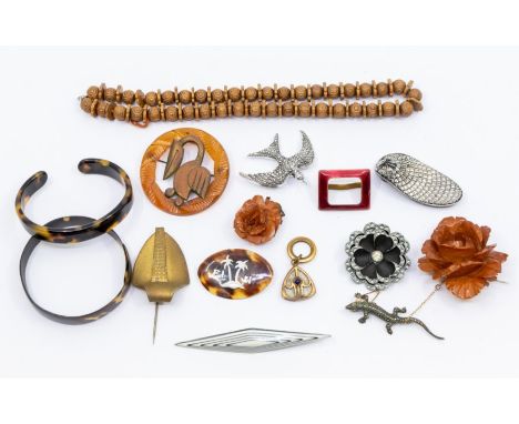 A collection of vintage jewellery including two rose carved amber type brooches, a gilt metal Art Nouveau style pendant, 1950