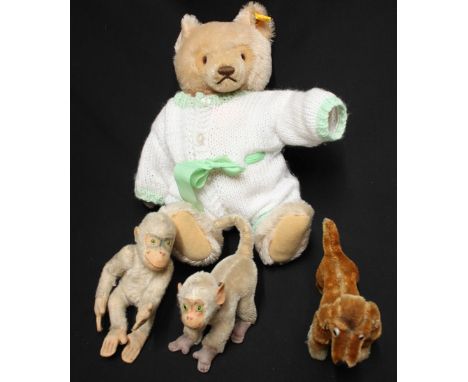 A Steiff mohair teddy bear, unboxed, together with two 1940s toy monkeys and a dog. (4)