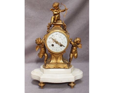 a Victorian gilt-bronze mantel clock of balloon form, surmounted by three cherubs, French 8-day movement striking a bell (bel