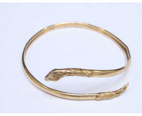 A 9ct gold snake bangle. 6.4 grams.