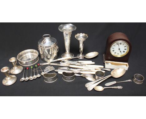 A pair of silver dwarf candlesticks, two silver spill vases, a pair of silver napkin rings, and other silver plated items, an