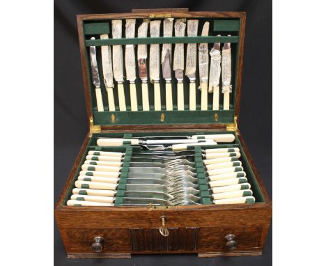 An Art Deco oak canteen of silver plated cutlery.
