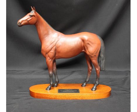 A Beswick ceramic model of a racehorse 'Red Rum' mounted on wooden base.