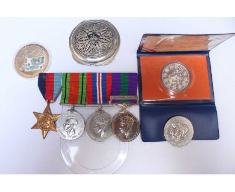 A group of three WWII medals, and a George VI GSM with Palestine 1945-48 clasp, together with three coins and an Eastern whit