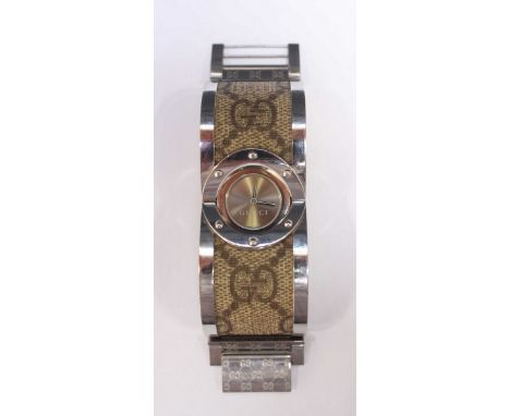 A ladies Gucci 11865103 Twirl bangle wristwatch, stainless steel case with plain silvered dial, swivelling movement set withi