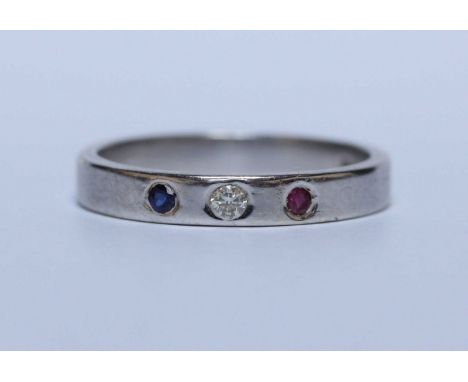 A 14K white gold, sapphire, diamond and ruby wedding band. 3.9 grams.