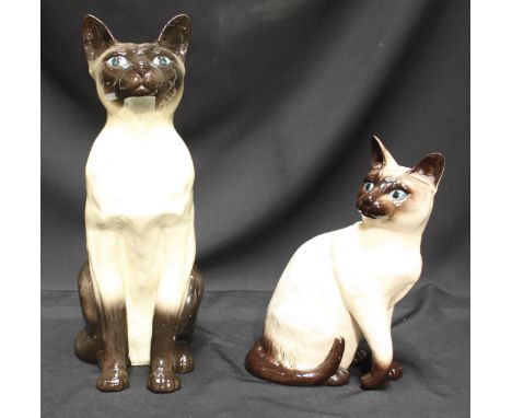 A Beswick ceramic figure of a Siamese cat together with a Royal Doulton ceramic model of a Siamese cat. Tallest figure measur