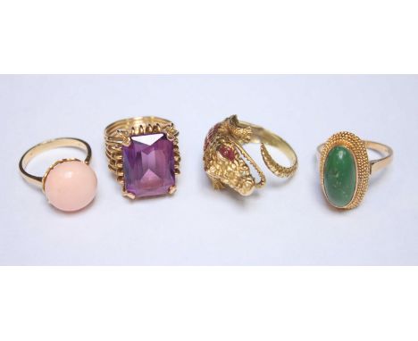 Four various 18ct gold dress rings, including a crocodile ring, a jade ring, and a coral ring. 27.6 grams.