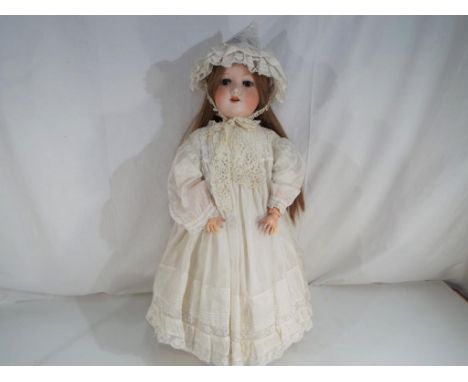Armand Marseile - a good quality bisque headed doll with sleeping glass eyes, open mouth bearing ceramic teeth, with jointed 