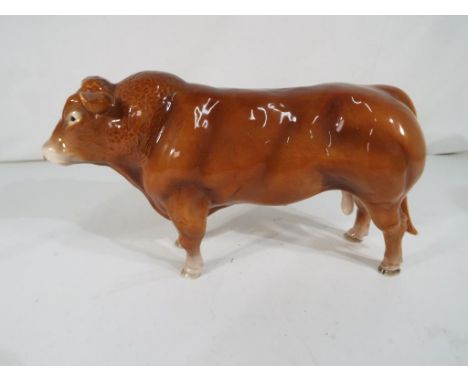 Beswick Pottery - A John Beswick ceramic model of a Limousin bull with ringed nose, approximately 13.5 cm (h).