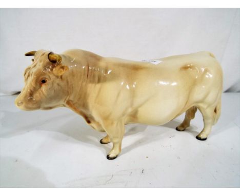 Beswick Pottery - A ceramic model of a Charolais bull by Beswick Pottery, approximately 12 cm (h)