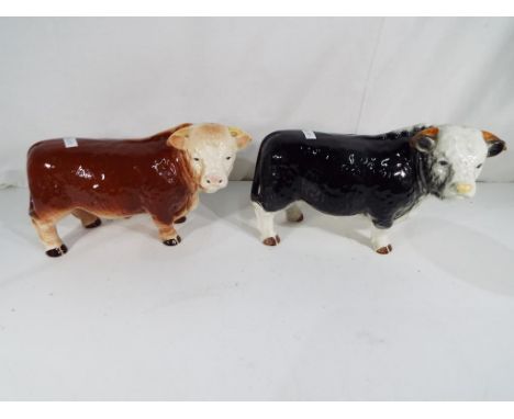 Two good quality Melba Ware ceramic models of bulls, one in black approximately 16 cm (h), the other brown approximately 15 c