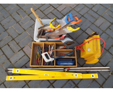 A quantity of hand tools to include saws, pliers, screwdrivers, also included in the lot are two builder's spirit levels, a R