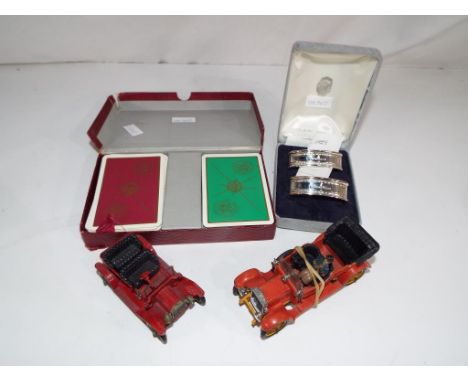 Two sets of British Road Services playing cards in presentation case, a pair of hallmarked silver napkin rings, cased, a Corg