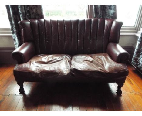 A brown leather high back two seater sofa, approx size 100cm x 160cm x 90cm