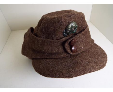 World War Two (WW2) - a German Army Heer M43 field hat with skull pin badge to the fore, the hat marked within I-K M.8 010 - 