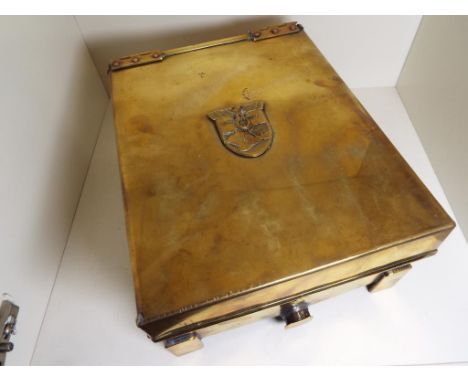 World War Two (WW2) - a brass chest on bracket feet, the hinged upper surface with applied 1941-1942 Krim shield decoration, 