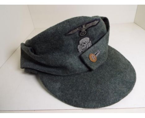 World War Two (WW2) - a German Army peaked cap with patch badges to the side and fore, marked within SS-BW 60 - NOTE: Please 
