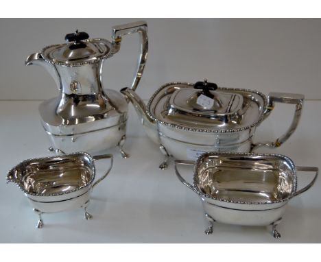 4 PIECE E.P.N.S. TEA SERVICE - TEAPOT, HOT WATER POT, SUGAR AND CREAM WITH EBONY FINIALS AND HEAT GUARD HANDLES     