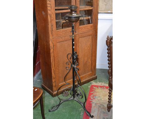 An Arts and Crafts wrought iron and brass Maple Hinks Patent, London oil lamp with telescopic stand.