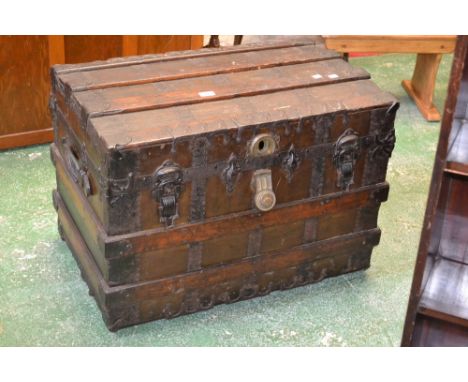 A metal and wood bound dome top travel trunk