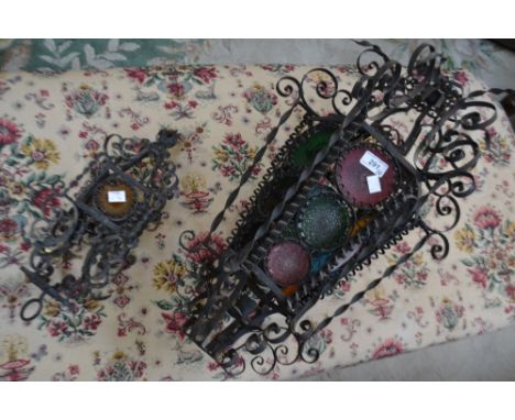 A wrought iron hanging lantern with circular glass panels, approx 68cm high; another, smaller, four circular coloured glass p