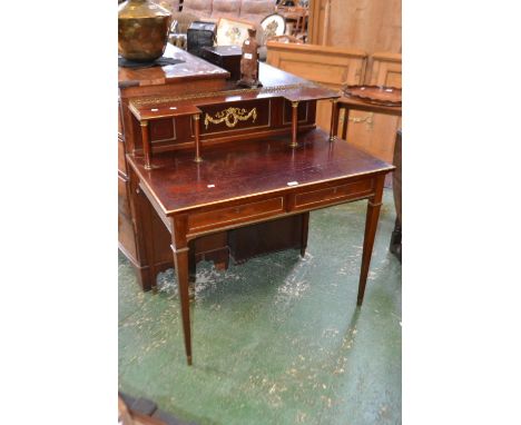 A Regency style writing desk, gallery with shelf supported by columns, two short drawers to frieze, tapering square supports,